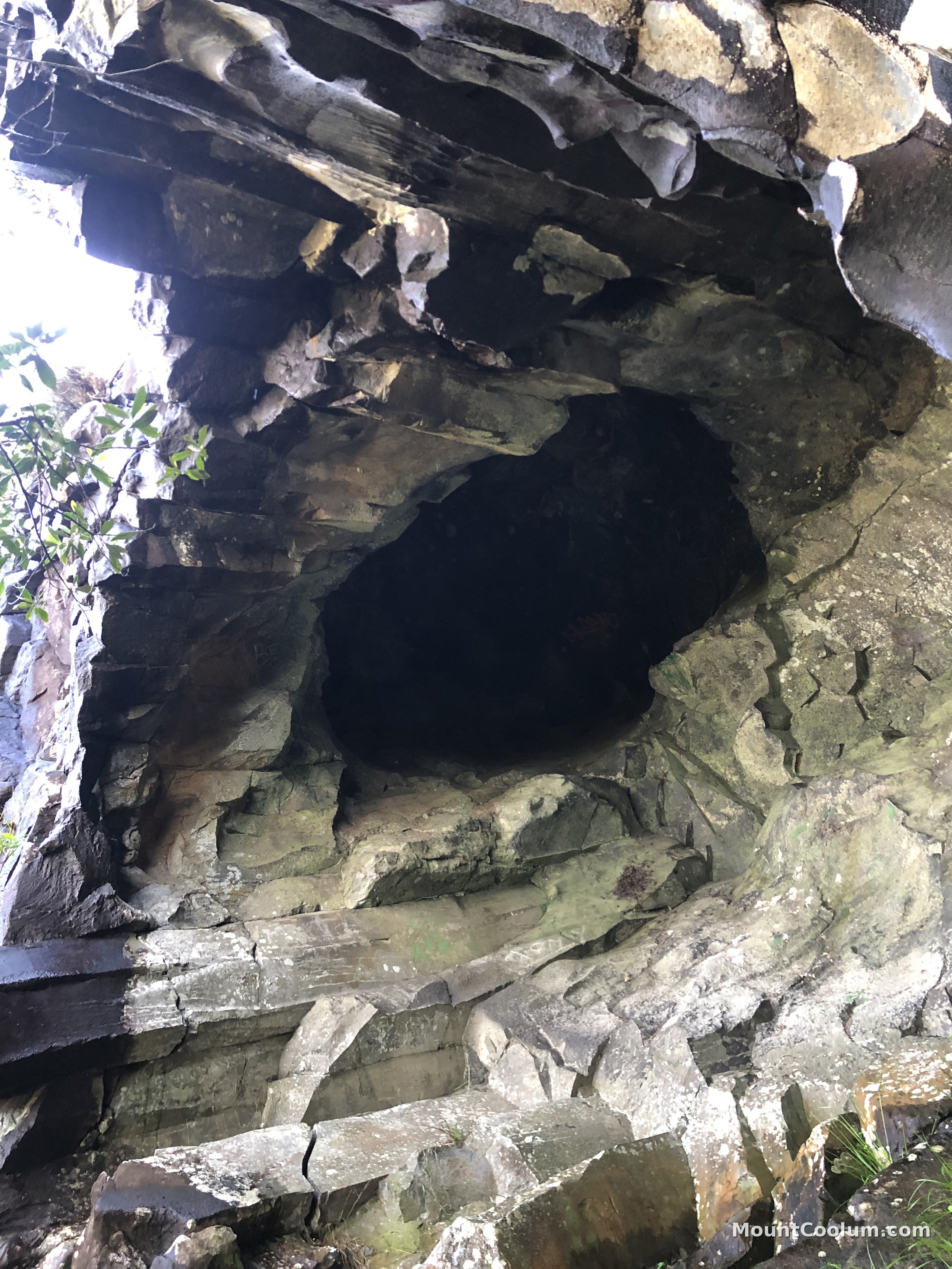 Dark entrance of the small climbing cave on Mount Coolum's south-eastern side
